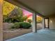 Covered patio providing a serene outdoor space with beautiful landscaping and gravel at 2114 Twin Falls Dr, Henderson, NV 89044