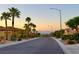 Palm tree-lined street with homes in a well-maintained neighborhood at dusk at 2114 Twin Falls Dr, Henderson, NV 89044