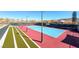 Overhead view of a tennis court with a red base, blue court, and green border at 2114 Twin Falls Dr, Henderson, NV 89044