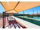 Tennis courts under the shelter with wooden benches and landscaped grounds at 2114 Twin Falls Dr, Henderson, NV 89044