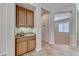 Cozy wet bar with built-in cabinets and granite countertop located next to the dining area at 2114 Twin Falls Dr, Henderson, NV 89044