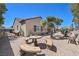 Private backyard featuring desert landscaping, rock fountain and comfortable seating area with serene views at 2320 Anderson Park Dr, Henderson, NV 89044