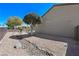 Low maintenance backyard featuring desert landscaping, rock features, and neutral color palette at 2320 Anderson Park Dr, Henderson, NV 89044