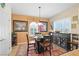 Cozy dining area featuring a glass table, dark wood accents, and stylish decor at 2320 Anderson Park Dr, Henderson, NV 89044