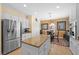 Eat-in kitchen boasts white cabinets, a stainless-steel refrigerator, and plenty of countertop space at 2320 Anderson Park Dr, Henderson, NV 89044