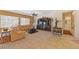 Spacious living room features a ceiling fan, lots of natural light, and neutral carpet at 2320 Anderson Park Dr, Henderson, NV 89044