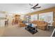 Open living and dining area with tan couch and plantation shutters for privacy at 2320 Anderson Park Dr, Henderson, NV 89044
