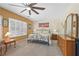 Comfortable main bedroom with large window and fan at 2320 Anderson Park Dr, Henderson, NV 89044