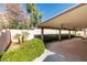Exterior shot of a covered patio with a lounge swing surrounded by lush foliage at 259 Baring Cross St, Henderson, NV 89074