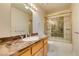 Bathroom featuring a marble countertop, sink, and a tiled shower with a glass door at 259 Baring Cross St, Henderson, NV 89074