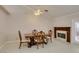 Elegant dining room featuring a fireplace, wainscotting, and a ceiling fan at 259 Baring Cross St, Henderson, NV 89074