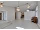 Open concept living area with tile floors, chandeliers, and views into the dining room and fireplace at 259 Baring Cross St, Henderson, NV 89074