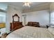 Comfortable main bedroom with wooden furniture, a leather couch, and a ceiling fan at 259 Baring Cross St, Henderson, NV 89074