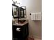 Bathroom featuring a vessel sink and decorative mirrors at 266 Lyra Ln, Las Vegas, NV 89110