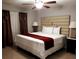 Bedroom showcasing a large bed with crisp white linens, accented by a brown throw and modern nightstands at 266 Lyra Ln, Las Vegas, NV 89110