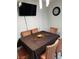 Dining room features a table with six chairs, modern lighting, and a mounted television and clock at 266 Lyra Ln, Las Vegas, NV 89110