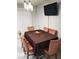 Dining room features a table with six chairs, modern lighting, and a mounted television at 266 Lyra Ln, Las Vegas, NV 89110