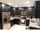 Contemporary kitchen featuring stainless steel appliances and dark cabinetry at 266 Lyra Ln, Las Vegas, NV 89110