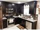 Contemporary kitchen featuring stainless steel appliances and dark cabinetry at 266 Lyra Ln, Las Vegas, NV 89110