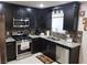 Updated kitchen with sleek black cabinets, stainless steel appliances, and granite countertops at 266 Lyra Ln, Las Vegas, NV 89110