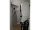 Bright laundry room features stacked washer/dryer, ironing board, and storage shelves at 266 Lyra Ln, Las Vegas, NV 89110