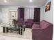 Cozy living room featuring comfortable sofas, a modern glass coffee table, and decorative wall art at 266 Lyra Ln, Las Vegas, NV 89110