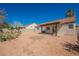 Expansive backyard featuring desert landscaping, a charming patio area, and ample space for outdoor enjoyment at 2719 Frangipani Ct, North Las Vegas, NV 89031