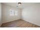 Cozy bedroom features wood-look floors, white walls, and bright window views at 2719 Frangipani Ct, North Las Vegas, NV 89031