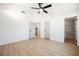 Bedroom with wood-look floors, white walls, multiple doors, and attached bathroom at 2719 Frangipani Ct, North Las Vegas, NV 89031