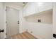 Functional laundry room offers overhead cabinets and modern white door at 2719 Frangipani Ct, North Las Vegas, NV 89031