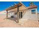Covered patio with concrete base provides ideal space for outdoor living and entertaining at 2719 Frangipani Ct, North Las Vegas, NV 89031