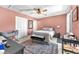 This bedroom features a ceiling fan, rug, and a sliding glass door for natural light at 2837 Canonero St, Las Vegas, NV 89142