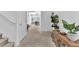 Inviting foyer with staircase, neutral carpet, and decorative console table leading to the main living areas at 2837 Canonero St, Las Vegas, NV 89142