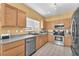 Well-lit kitchen featuring stainless steel appliances, tile floors, and light wood cabinetry at 2837 Canonero St, Las Vegas, NV 89142