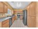 Well-lit kitchen features stainless steel appliances, ample counter space, and wood cabinetry at 2837 Canonero St, Las Vegas, NV 89142