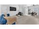 Spacious living room with a comfortable blue sofa, modern decor, and ample natural light at 2837 Canonero St, Las Vegas, NV 89142