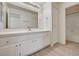 Bright bathroom featuring a single sink, white cabinetry, and a large mirror at 2917 Broken Willow Cir, Las Vegas, NV 89117