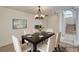 Staged dining room with seating for six and view of staircase at 2917 Broken Willow Cir, Las Vegas, NV 89117