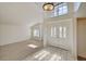 Bright foyer with tile flooring, a soaring ceiling and adjacent living room at 2917 Broken Willow Cir, Las Vegas, NV 89117