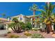 Charming home featuring a tile roof, desert landscaping, and an attached three car garage at 2917 Broken Willow Cir, Las Vegas, NV 89117