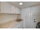 Functional laundry area with sink, cabinets and easy access to outside at 2917 Broken Willow Cir, Las Vegas, NV 89117