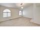 Bright living room featuring modern wood flooring, arched windows and natural light at 2917 Broken Willow Cir, Las Vegas, NV 89117
