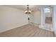 Bright open-concept living room showcasing a decorative chandelier and tiled foyer at 2917 Broken Willow Cir, Las Vegas, NV 89117