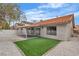 Private backyard with an artificial lawn, desert landscaping, and covered patio area at 3104 Waterview Dr, Las Vegas, NV 89117