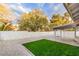 Backyard featuring a synthetic grass area, covered patio, and a block wall at 3104 Waterview Dr, Las Vegas, NV 89117