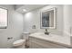 Bright bathroom featuring a vanity, white countertop, dark fixtures, and a toilet with wood-look flooring at 3104 Waterview Dr, Las Vegas, NV 89117