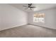 Spacious bedroom with neutral carpet, large window, bright natural light, and modern ceiling fan at 3104 Waterview Dr, Las Vegas, NV 89117