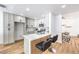 Modern kitchen with an island, breakfast bar, stainless steel appliances, and light gray cabinetry at 3104 Waterview Dr, Las Vegas, NV 89117