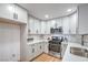 Well-lit kitchen with white cabinets, stainless steel appliances, and sleek countertops at 3104 Waterview Dr, Las Vegas, NV 89117