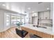 Modern kitchen with quartz countertops, stainless steel sink and faucet, light wood floors, and bright white cabinets at 3104 Waterview Dr, Las Vegas, NV 89117